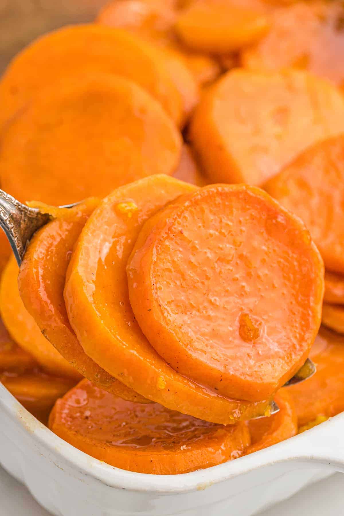 A serving fork with a scoop of candied yams recipe close up