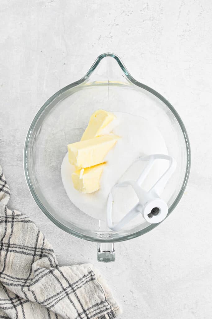 Butter and sugar in the mixing bowl of a stand mixer.