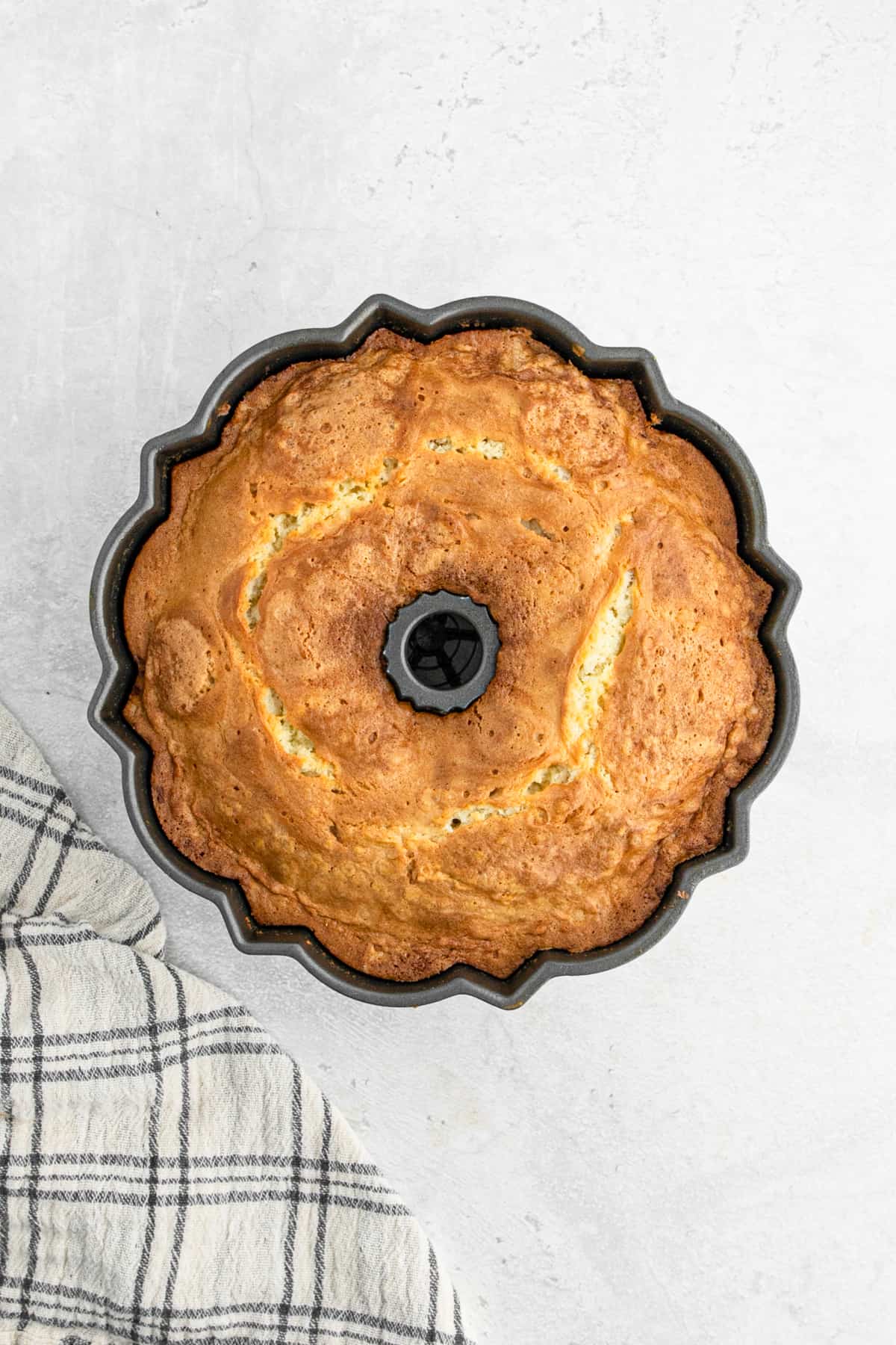 Baked almond pound cake still in the cake pan.