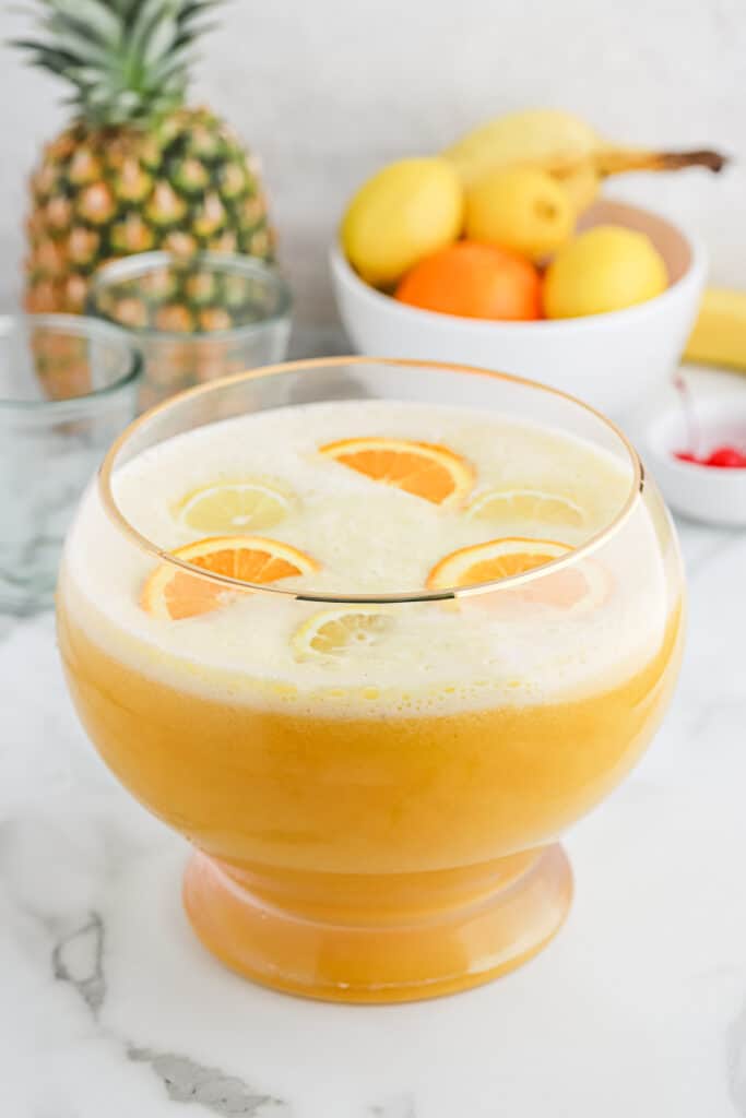 Overhead of fully made fruit punch bowl filled with sliced oranges.