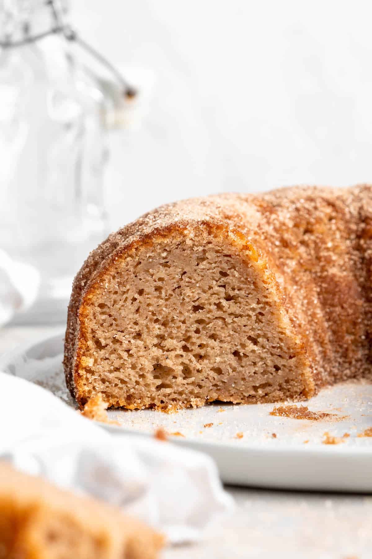 A close up of a cut open apple cider donut bundt cake ready to enjoy