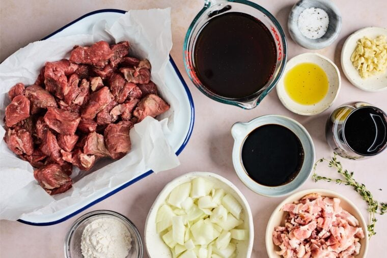 Beef pieces, stock, spices and ingredients to make easy beef tip recipe on countertop