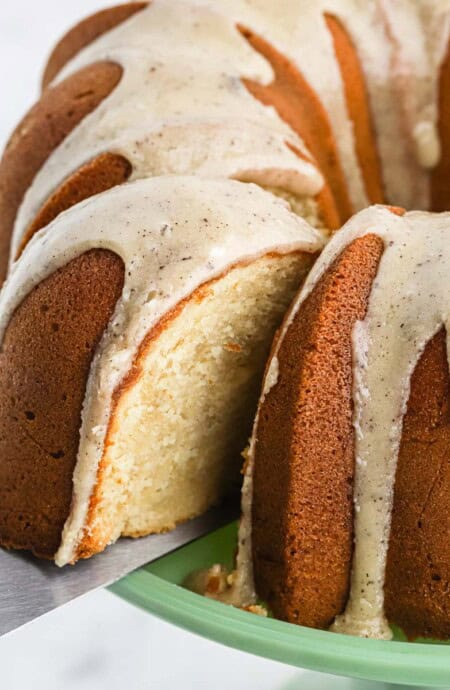 Brown sugar pound cake with a slice of cake on a spatula coming out from the cake.