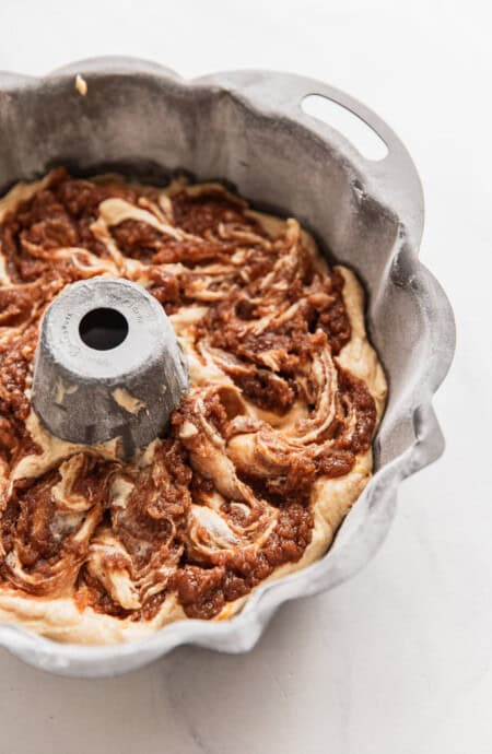 Cake batter swirled in a bundt pan after using homemade cake release