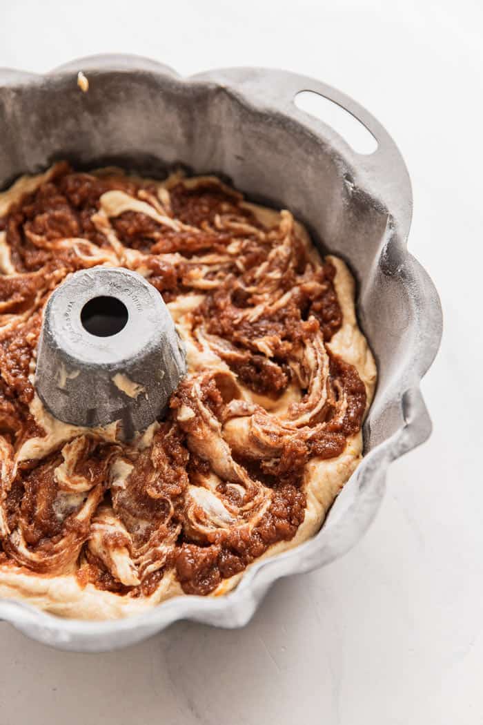 Cake batter swirled in a bundt pan after using homemade cake release