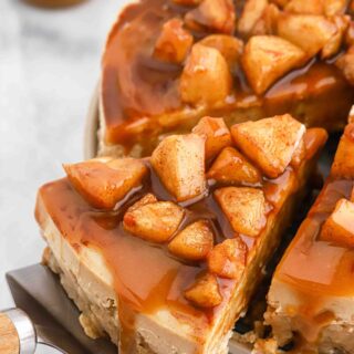 Caramel Apple Cheesecake Recipe slice being pulled out on white background