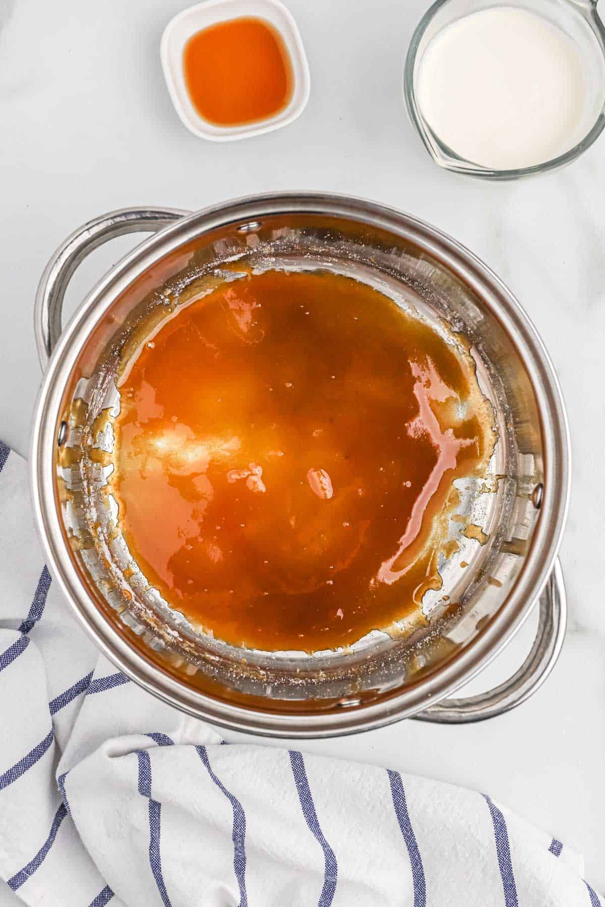 Sugar is beginning to brown in a pot to make caramel sauce.