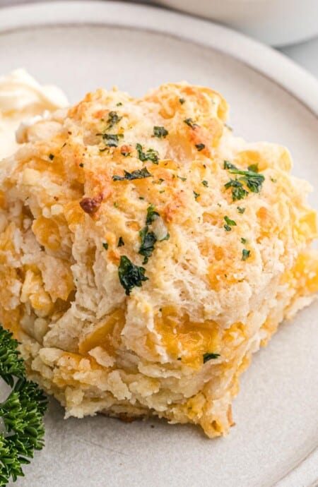 A cheddar bay biscuit on a plate.