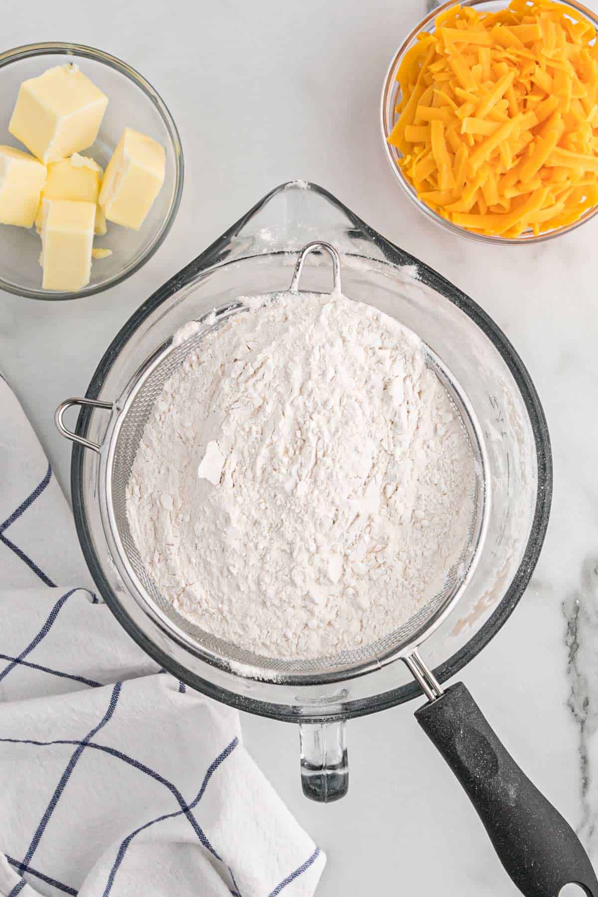 Flour and other dry ingredients sifted into a bowl.