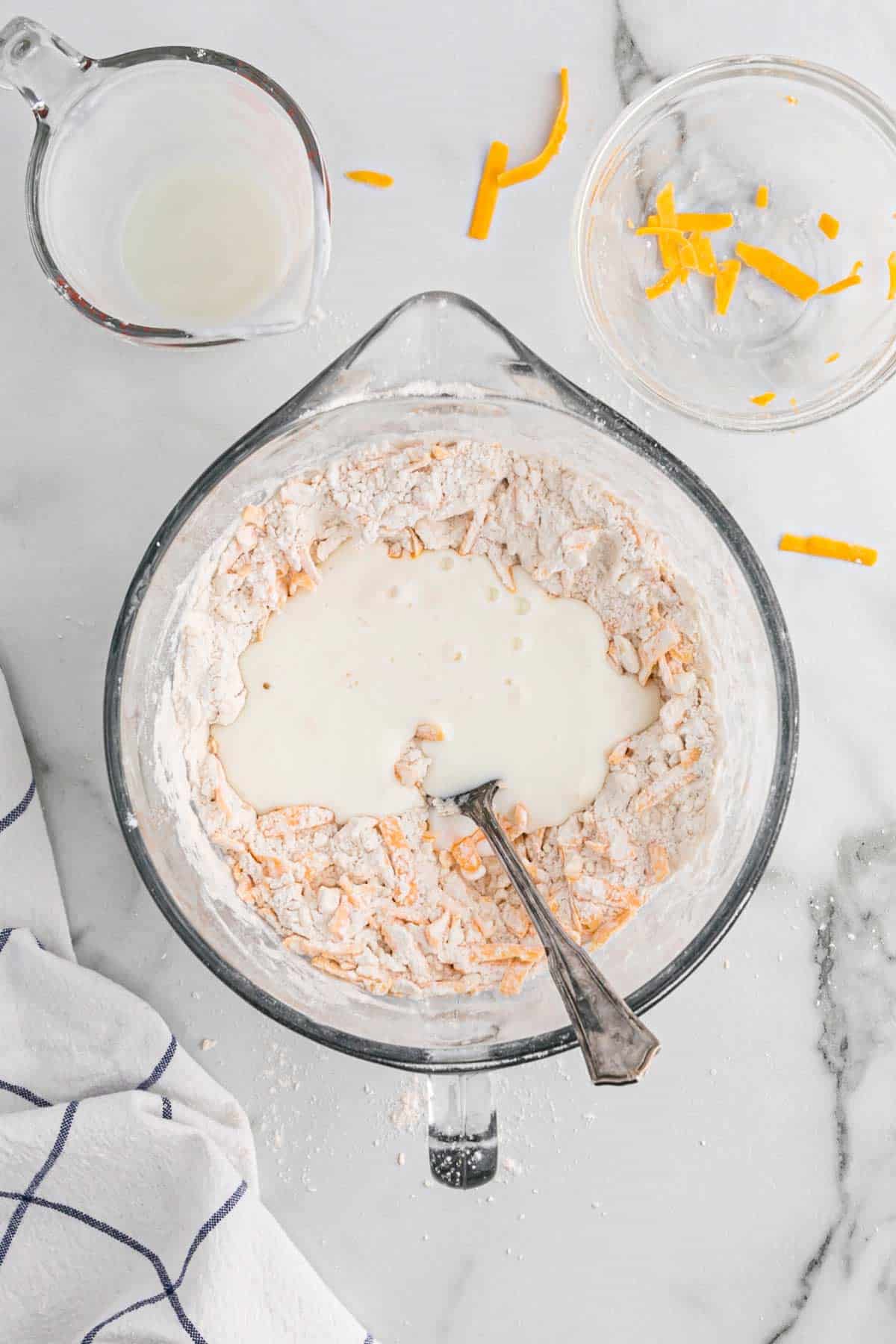 Buttermilk added to the bowl in the center of the dry ingredients.