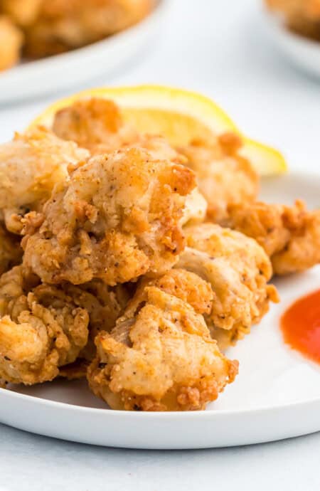 Close up of fried chicken gizzards on a plate.