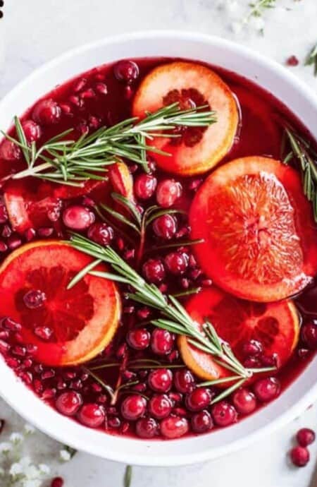 Best christmas punch served in a punch bowl with floating fruit.