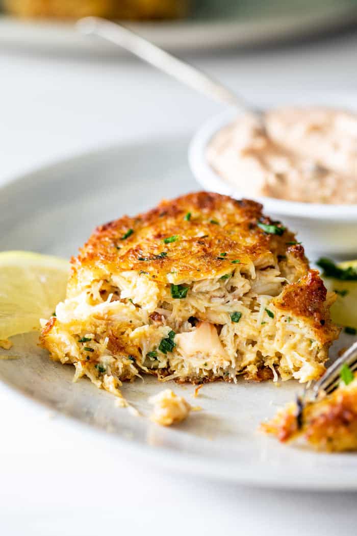 A close up of crab cakes ready to cut into