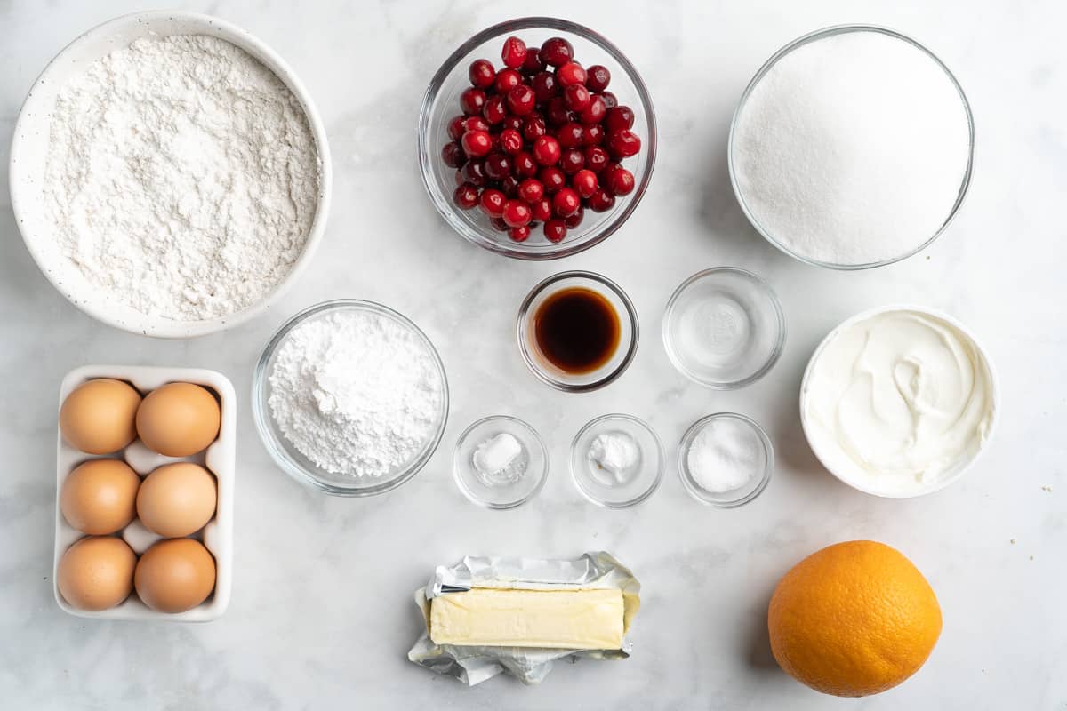 Ingredients to make cranberry orange cake on the table before mixing.