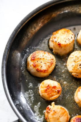 scallops searing in a pan