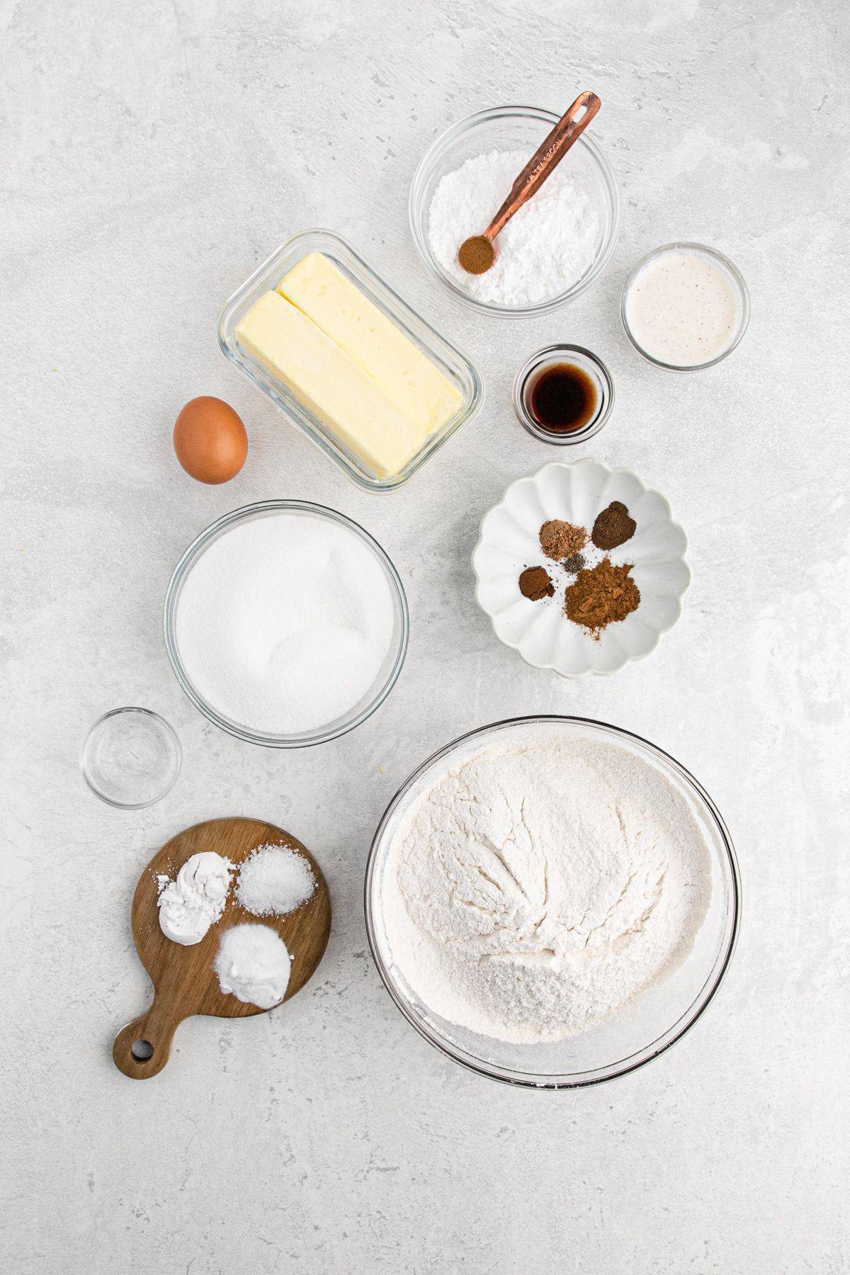 Ingredients to make eggnog cookies with eggnog on the table before mixing.