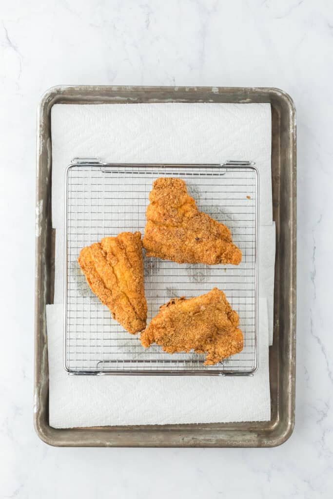 Southern fried catfish after being fried on a wire rack letting it drain