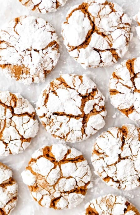 Gingerbread cookies on a white background with powdered sugar on top