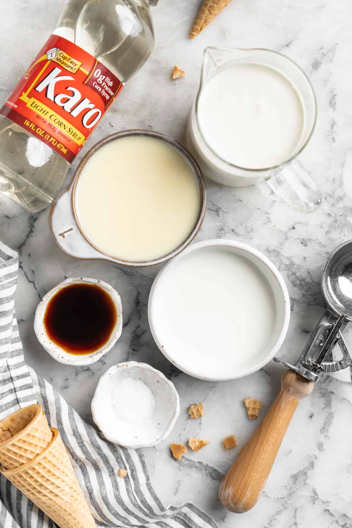 Ingredients to make vanilla no churn ice cream in small bowls.