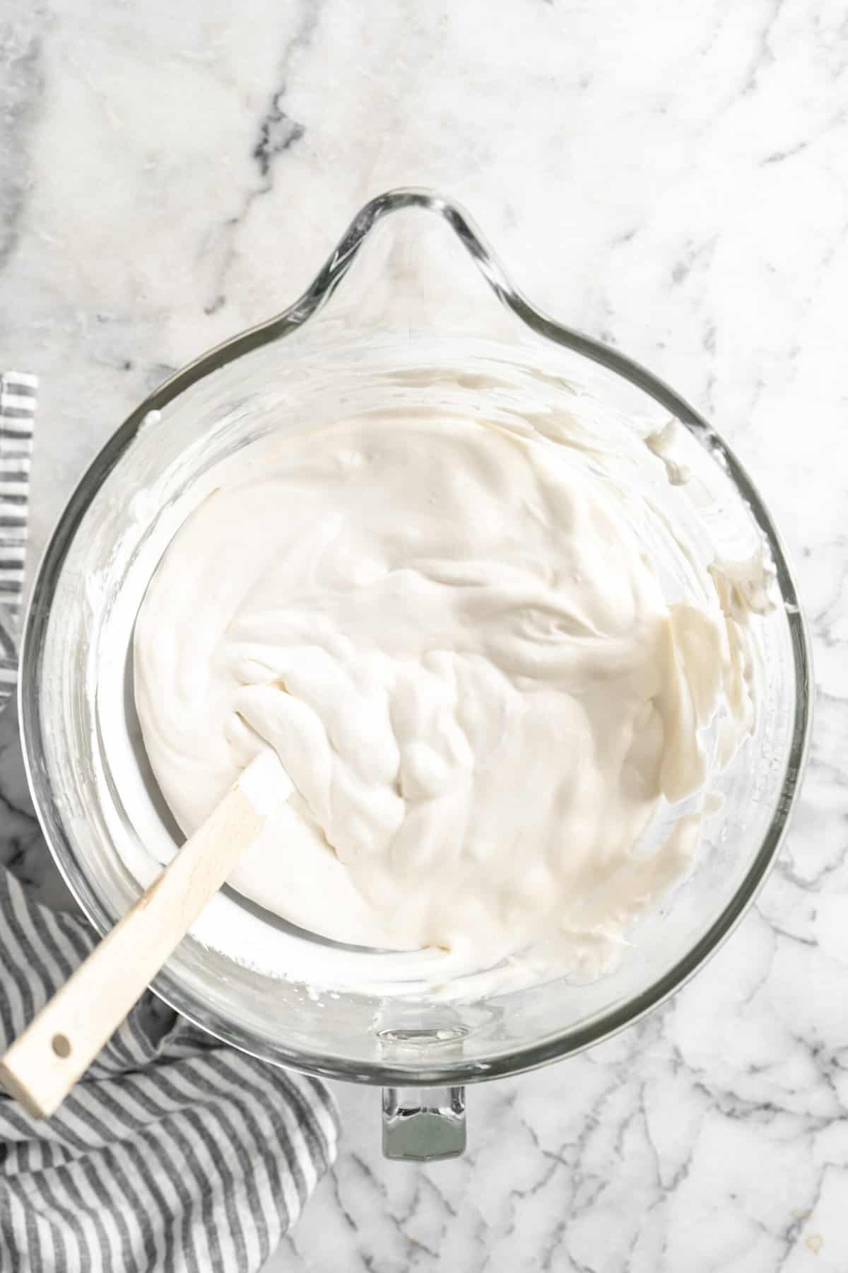 Vanilla ice cream in a glass stand mixer bowl.