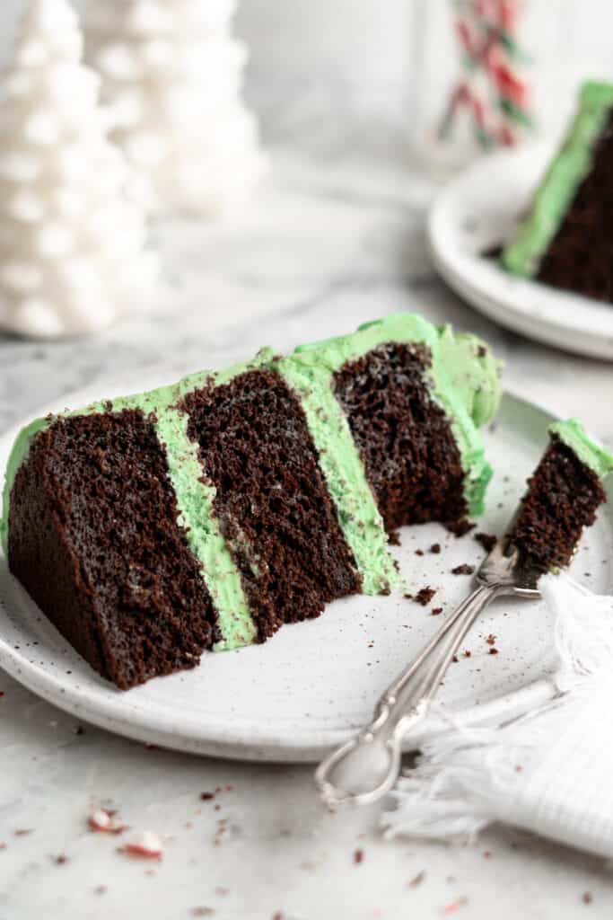 A large slice of cake on a plate with a fork