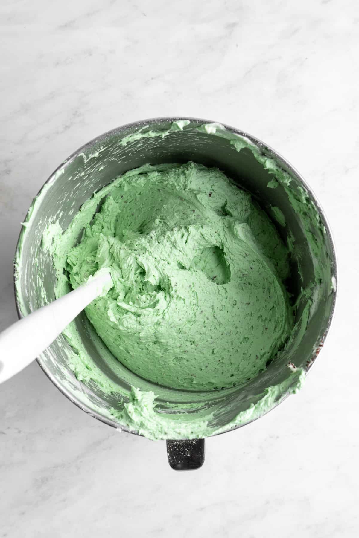 green buttercream in a medium bowl