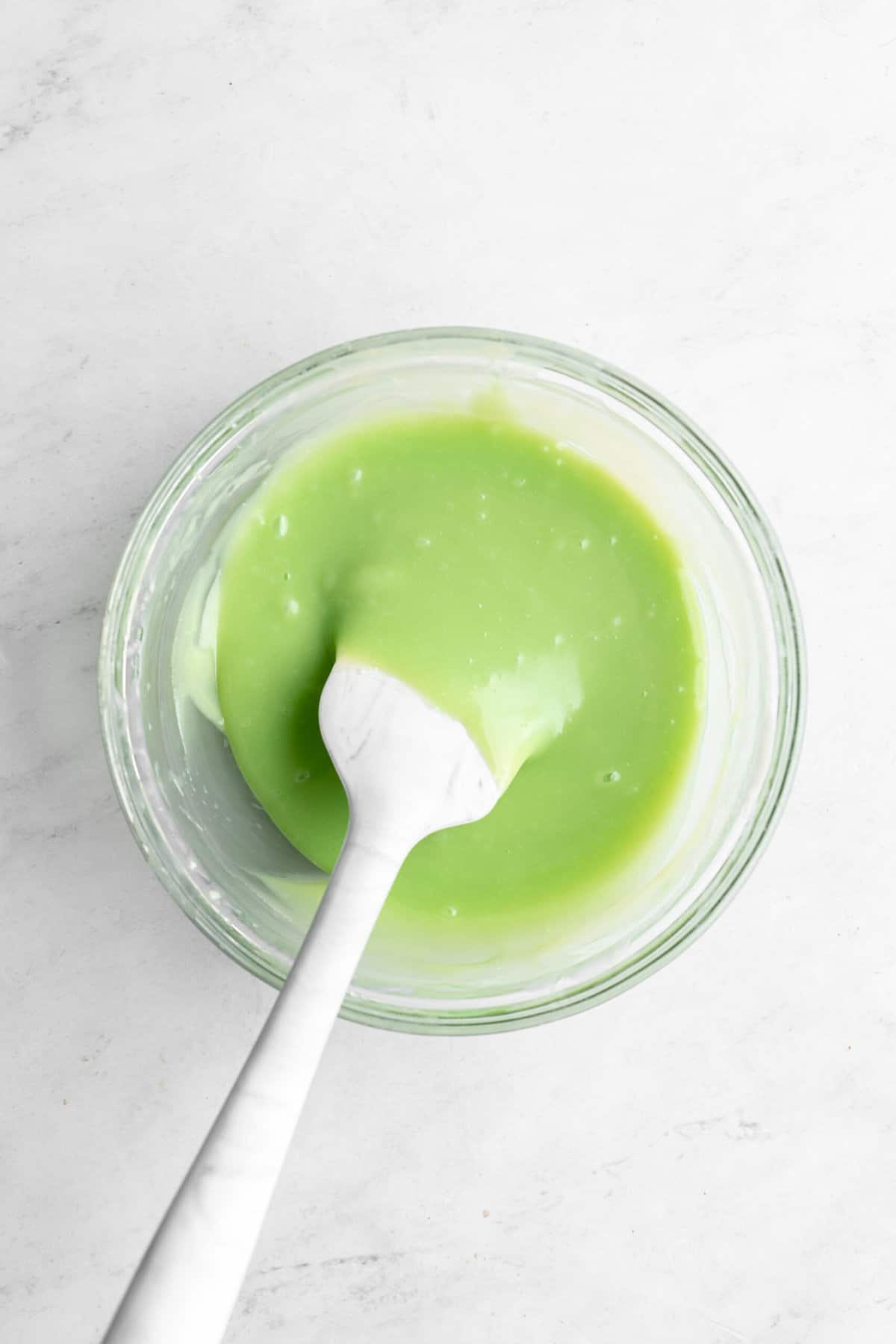 green melted chocolate in a small bowl