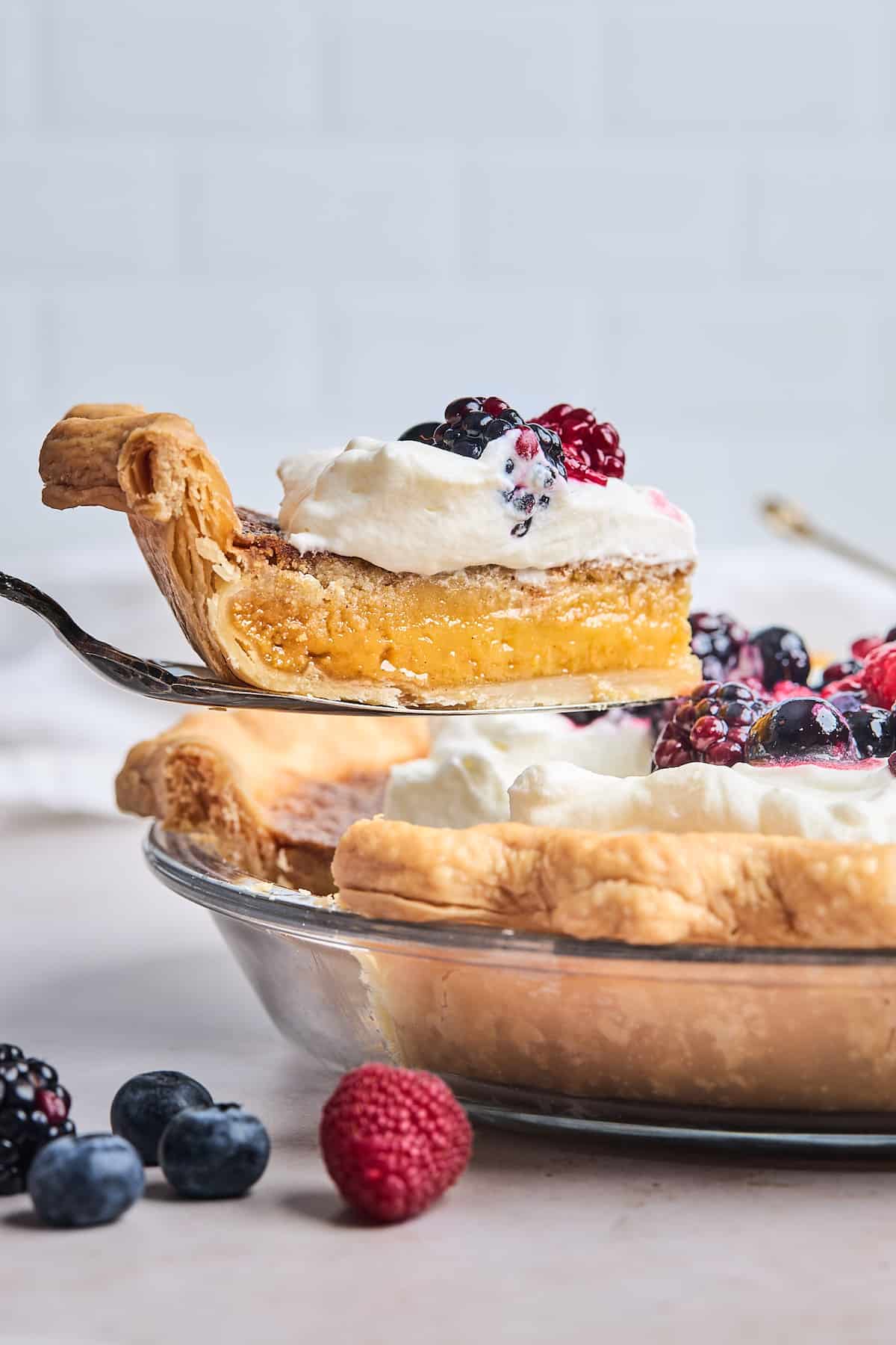 A slice of honey pie being lifted from the pan.