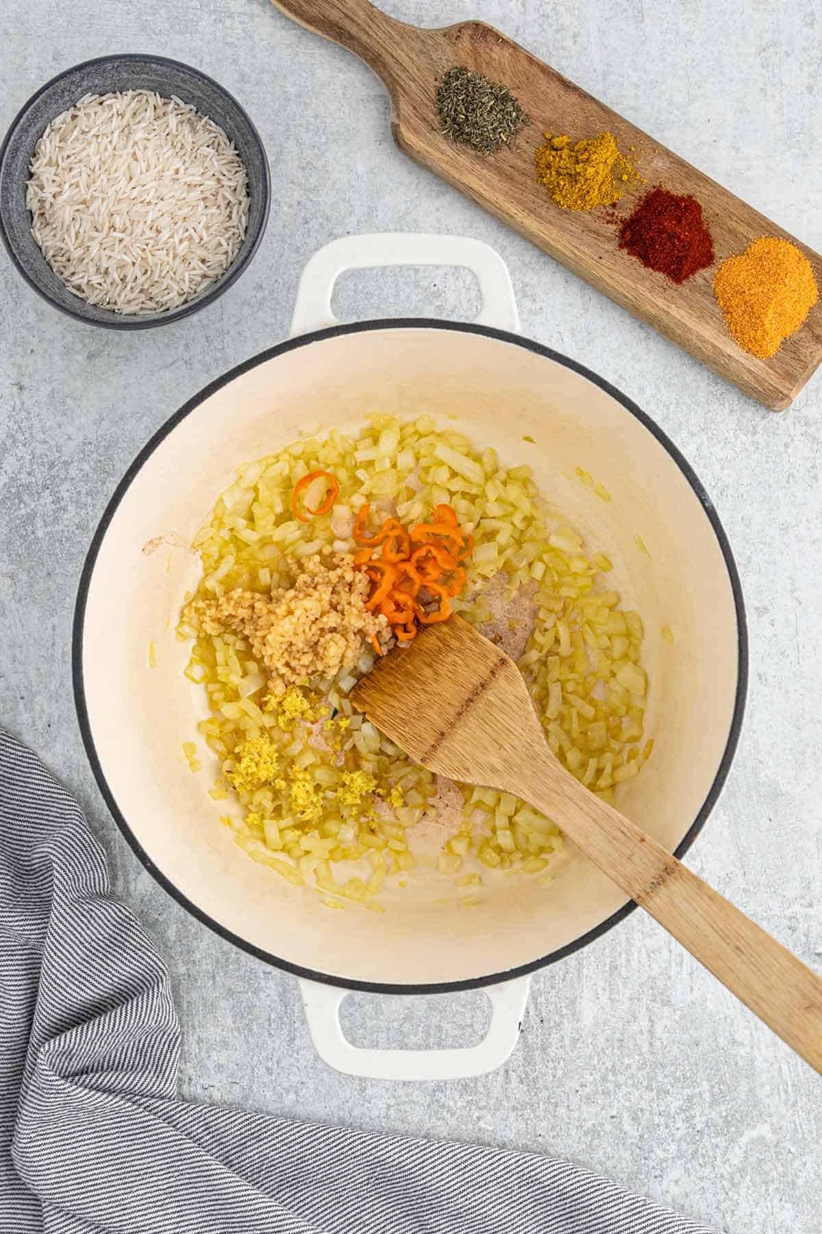 Cooking the onions, garlic and ginger in a pot.
