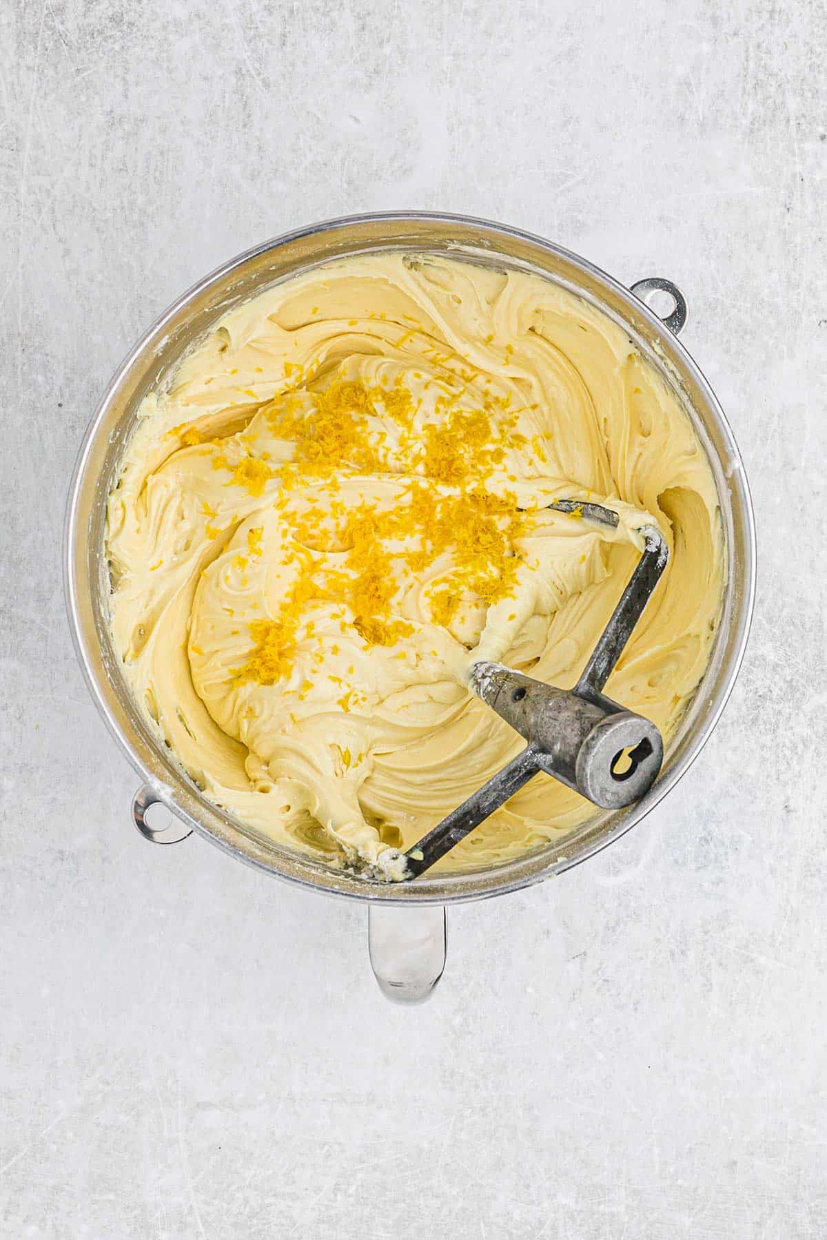 Lemon zest added to the lemon cake batter in the mixing bowl.