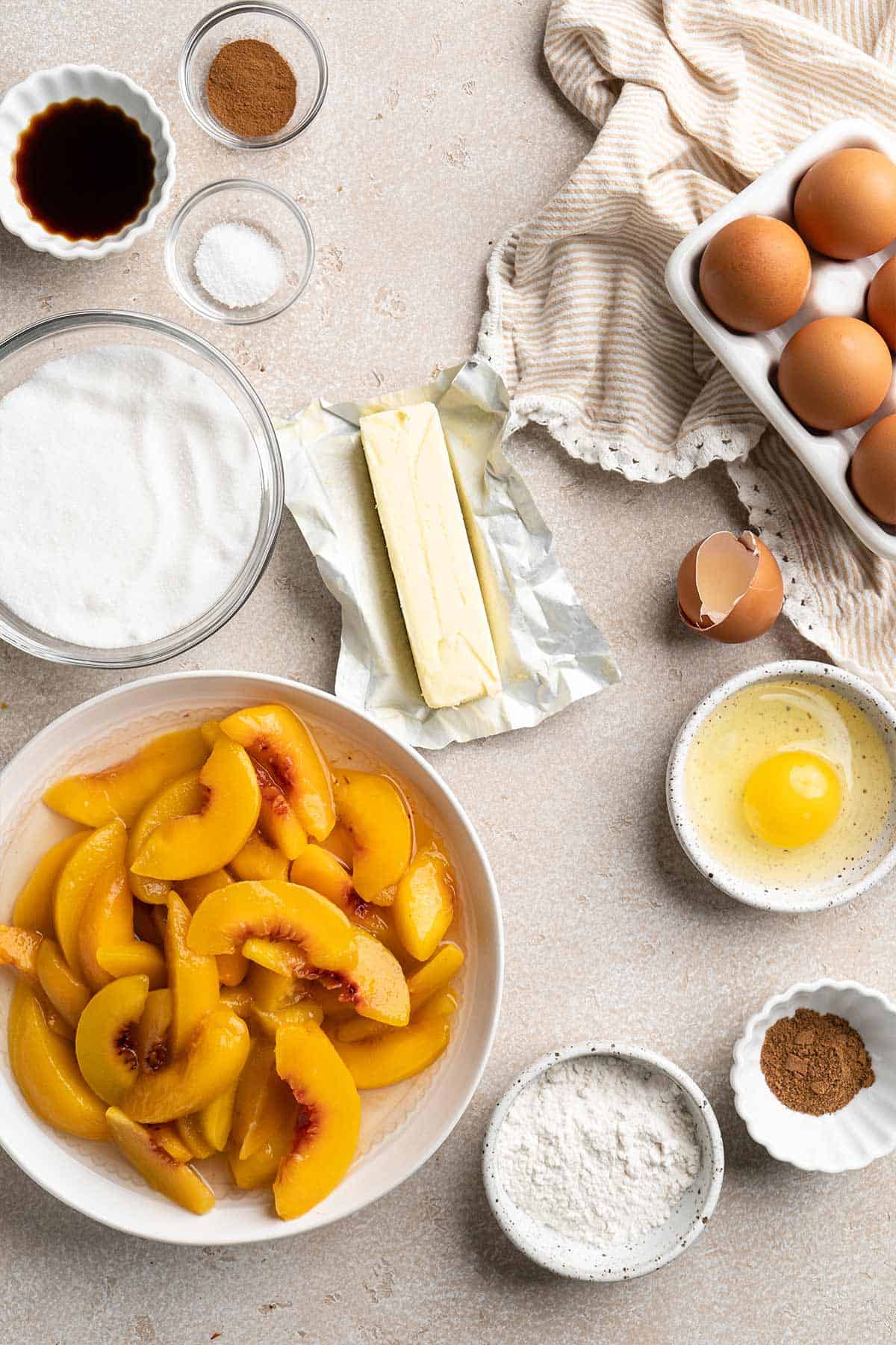 Ingredients to make peach cobbler on the table.