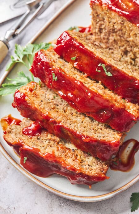 A close up of the most perfect meatloaf ever with slices ready to serve