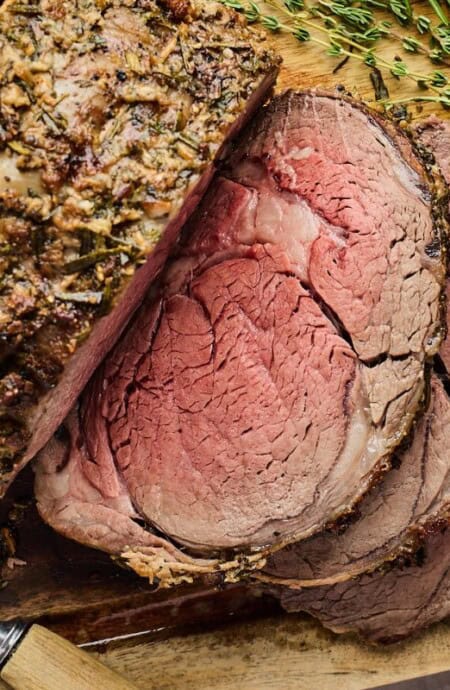 Juicy prime rib recipe sliced on a wooden cutboard