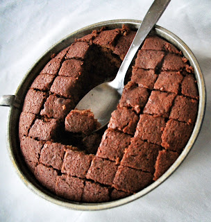 Pot of baked gingerbread cut into squares.