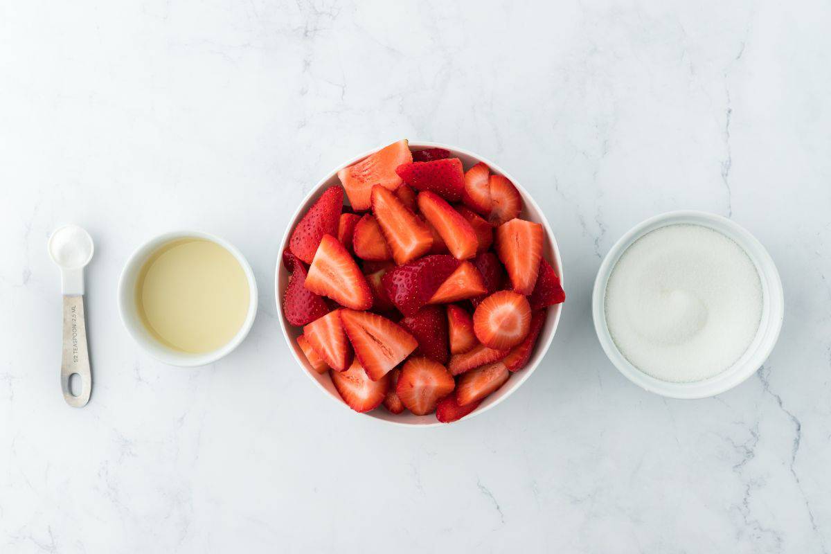 Overhead shot of ingredients to make strawberry preserves on the table before mixing