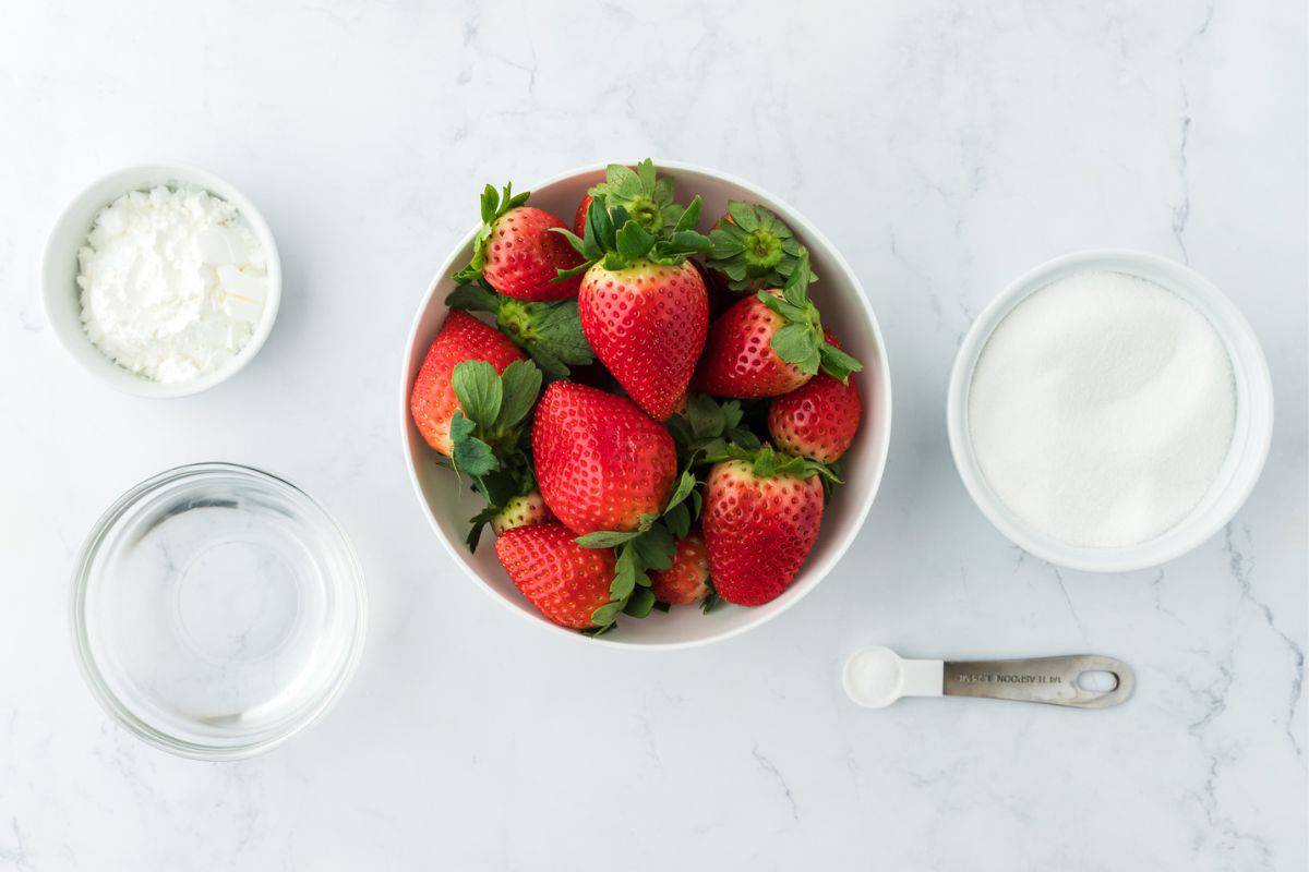 Overhead shot of ingredients to make strawberry sauce on the table before mixing
