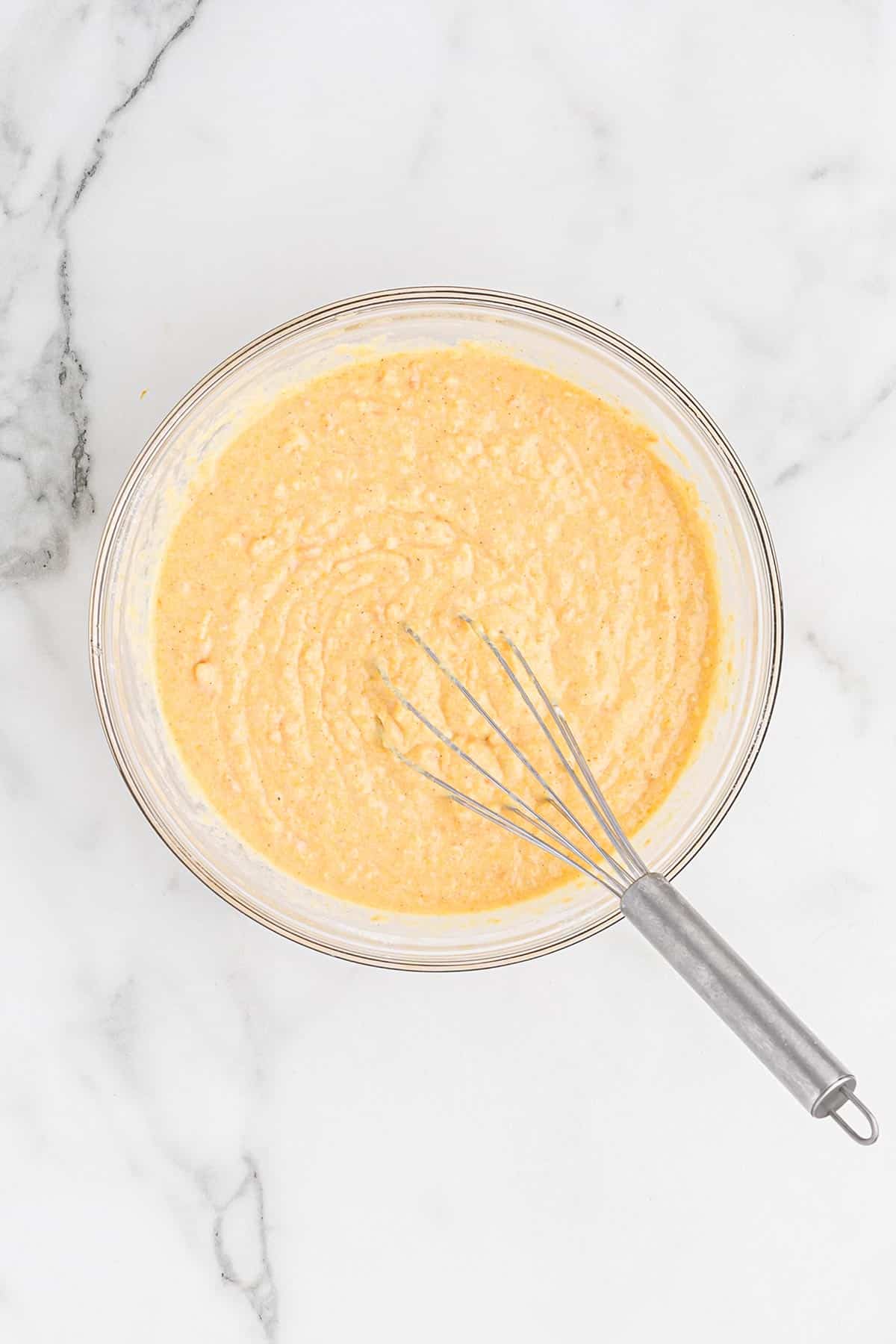 Mixed batter to make sweet potato cornbread muffins.
