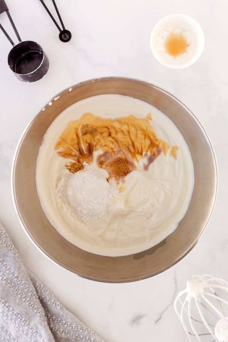 Heavy whipping cream whipped to soft peaks with sugar and vanilla added to a silver mixing bowl