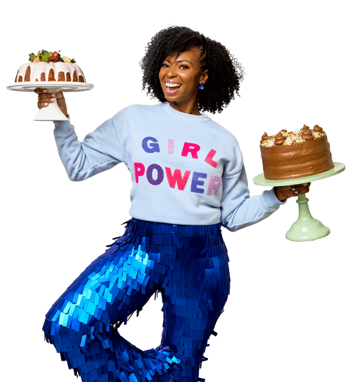 Jocelyn smiling while holding two cakes